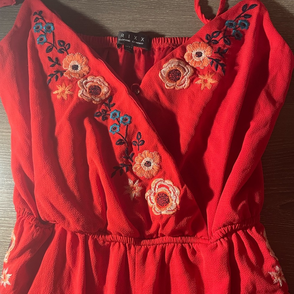 red romper with embroidered floral designs